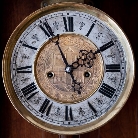 Photo for Old wooden clock with a pendulum hanging on the wall - Royalty Free Image