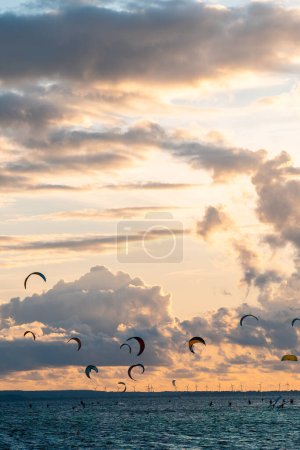 Photo for Professional kite surfing on ocean or sea sunset, kitesurfing training at water. High quality picture - Royalty Free Image
