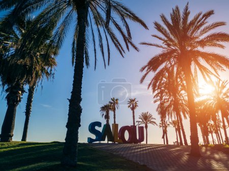 colorful letters of Salou town, palm trees and coastal beach, Catalonia, Spain. High quality photo