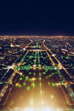 aerial view of illuminated night city panorama of Paris with street lights, drone top view from above, Champs Elysees and Elysee Palace, France. High quality photo