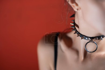 young woman in leather collar with metal spikes and ring, female in choker wit metallic elements. High quality photo