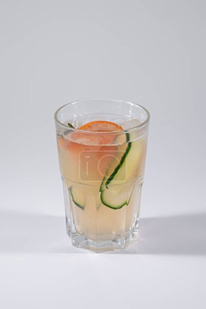 gin fizz cold ice cocktail with grapefruit and cucumber isolated on white. High quality picture