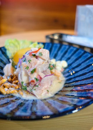 Photo for Peruvian ceviche served on a blue plat. - Royalty Free Image