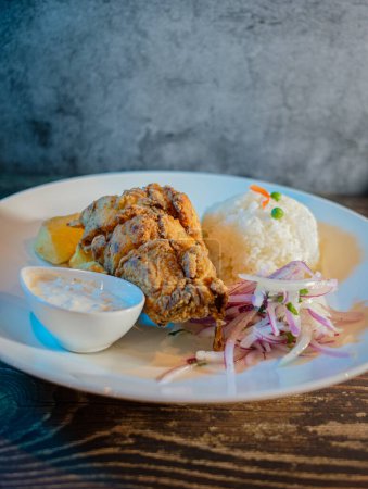 Photo for Fried fish filet with white rice, potatoes and salad - Royalty Free Image