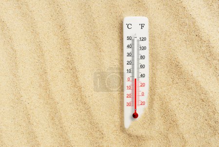 Foto de Día caluroso de verano. Termómetro a escala Celsius y fahrenheit en la arena. Temperatura ambiente más 7 grados - Imagen libre de derechos