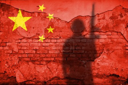 Photo for Flag of China painted on a concrete wall with soldier shadow - Royalty Free Image
