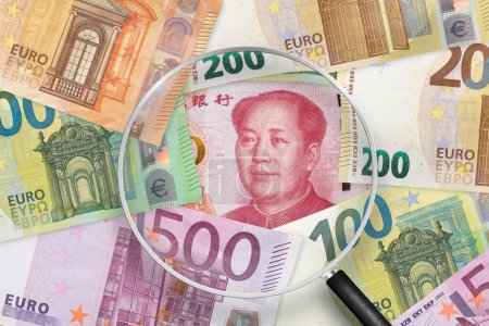 Photo for Chinese yuan and Euros banknotes. EU and China trade war . View through magnifying glass - Royalty Free Image