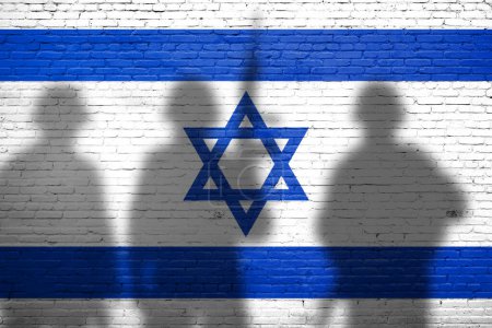 Flag of Israel painted on the brick wall with soldiers shadows. Gaza and Israel conflict. Terrorist organizations hezbollah and hamas