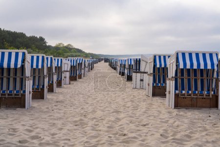 Sandy beach and traditional sun loungers at sunset, Northern Germany, on the Baltic Sea coast. Germany 