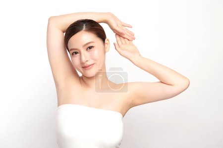 Photo for Beautiful Young Asian woman lifting hands up to show off clean and hygienic armpits or underarms on white background, Smooth armpit cleanliness and protection concept - Royalty Free Image