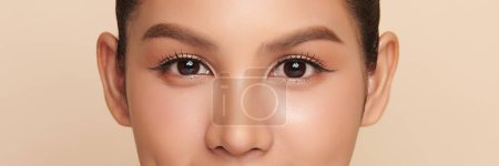 Photo for Close up of beauty asian woman eye on beige background. - Royalty Free Image
