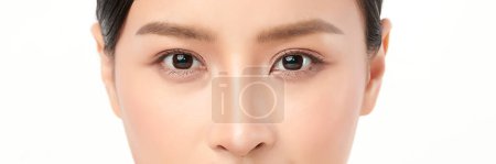 Téléchargez les photos : Close-up shot of beautiful Asian woman's eyes on white background. - en image libre de droit