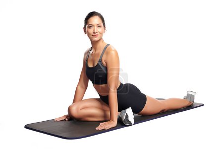 Photo for An asian woman is  working out  wearing the sport exercise suit with white background, - Royalty Free Image
