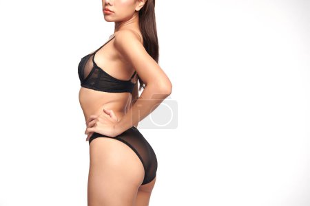 Photo for Confident beautiful young asian woman posing in black lingerie on white background, Perfect body, - Royalty Free Image