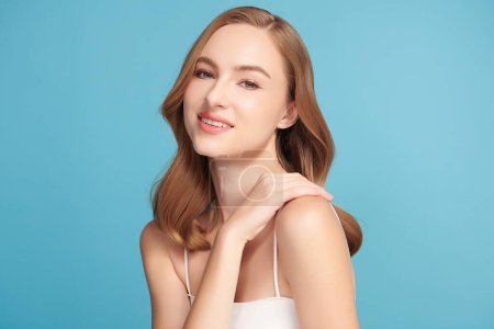Photo for Beautiful young woman with clean fresh skin on blue background, Face care, Facial treatment, Cosmetology, beauty and spa, women portrait. - Royalty Free Image