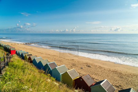Photo for Colourful beach huts on the beach in Mundesley, North Norfolk, UK on a summer morning - Royalty Free Image