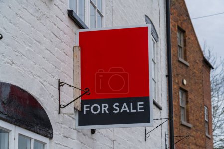 Photo for Red and Black for sale sign on the side of a house, New house purchase concept - Royalty Free Image
