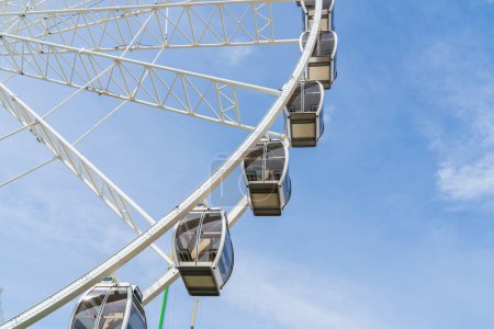 Photo for Gondolas on a large white Ferris Wheel with a blue sky - Royalty Free Image