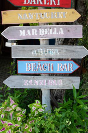 Photo for Wooden hand-painted signs of direction to many places in a resort. Colorful art craft piece with a local sense. - Royalty Free Image