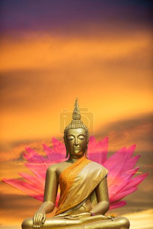A peaceful superimposed or double exposure images of Golden Buddha statue with a nice background from Ayuthaya, Thailand and a pink lotus. Buddha statue is posing The attitude of subduing Mara".