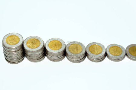 Photo for Stacks of 1 LE EGP one Egyptian pound coins cash isolated on white background, Egypt currency exchange rate concept with foreign currencies, selective focus of Egypt coinage - Royalty Free Image