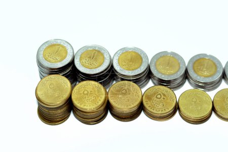 Photo for Stacks of 1 LE EGP one Egyptian pound coins cash and 50 fifty Egyptian piasters half a pound coins isolated on white background, Egypt currency exchange rate concept, selective focus - Royalty Free Image