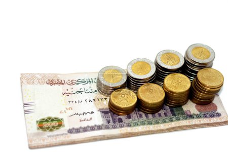 Photo for Pile of 200 EGP LE two hundred Egyptian pounds money banknotes with stacks of 1 LE EGP one pound coins and 50 fifty piasters half a pound coins isolated on white background, selective focus - Royalty Free Image