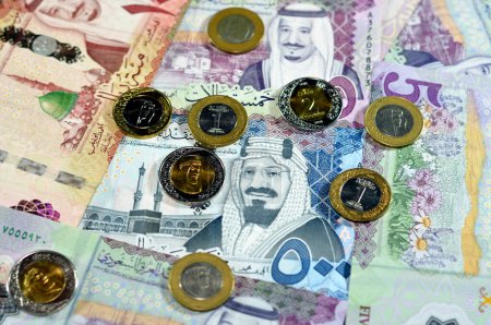 Photo for Saudi Arabia riyals money banknotes and coins, a pile of 500 SAR, 100 Saudi riyals and 5 riyals with 1, 2 riyals coins features king Salman bin AbdulAziz and king AbdulAziz, Saudi money exchange rate - Royalty Free Image