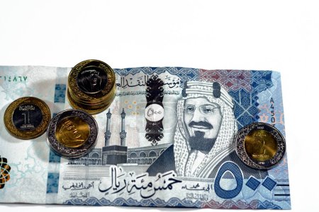 Photo for 500 SAR five hundred Saudi Arabia riyals cash money banknote with pile of Saudi riyal coins 1 and 2 riyals features king Salman Bin AbdulAziz Al Saud and King AbdulAziz, Saudi money exchange rate - Royalty Free Image