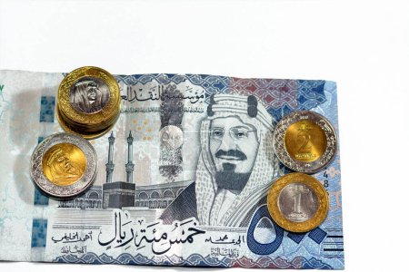 Photo for 500 SAR five hundred Saudi Arabia riyals cash money banknote with pile of Saudi riyal coins 1 and 2 riyals features king Salman Bin AbdulAziz Al Saud and King AbdulAziz, Saudi money exchange rate - Royalty Free Image