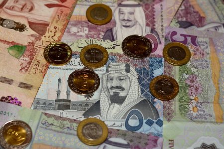 Photo for Saudi Arabia riyals money banknotes and coins, a pile of 500 SAR, 100 Saudi riyals and 5 riyals with 1, 2 riyals coins features king Salman bin AbdulAziz and king AbdulAziz, Saudi money exchange rate - Royalty Free Image