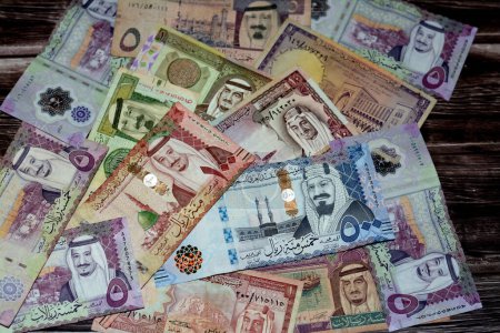 Photo for Saudi Arabia riyals money banknotes collection of different times and values feature portraits of Al Saud kings of Saudi Arabia, selective focus of Saudi currency, vintage retro, gulf economy - Royalty Free Image