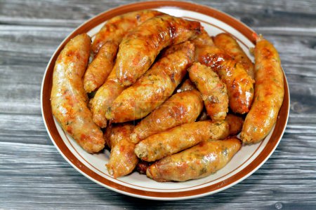 Photo for Egyptian classic homemade sausage of deep fried stuffed mumbar which is basically intestines that are filled with spicy rice, herbs, onion, and tomato , cooked then deep fried, selective focus - Royalty Free Image