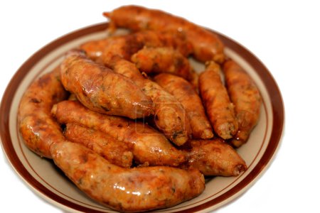 Photo for Egyptian classic homemade sausage of deep fried stuffed mumbar which is basically intestines that are filled with spicy rice, herbs, onion, and tomato , cooked then deep fried, selective focus - Royalty Free Image