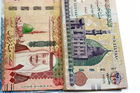 Photo for One hundred Saudi Arabia riyals cash money banknote 100 SAR features king Salman and the prophet mosque with 200 LE EGP two hundred Egyptian pounds features Qani Bay mosque, money exchange rate - Royalty Free Image