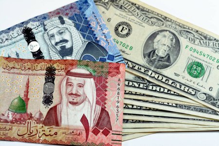 Photo for Collection of 500, 100 SAR Five hundred and one hundred Saudi Arabia riyals cash money banknotes with pile of 20, 1 and 2 $ twenty, one and two American dollars cash bills, money exchange rate - Royalty Free Image