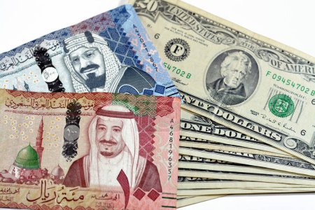 Photo for Collection of 500, 100 SAR Five hundred and one hundred Saudi Arabia riyals cash money banknotes with pile of 20, 1 and 2 $ twenty, one and two American dollars cash bills, money exchange rate - Royalty Free Image