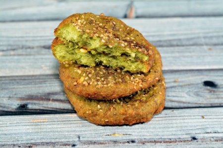 Photo for Traditional Egyptian fried falafel balls, green burger, made of ground chickpeas and broad beans, deep fried balls or patty-shaped fritter stuffed with minced onions and chili red peppers - Royalty Free Image
