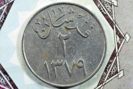 Photo for Translation of Arabic (Two Piaster 1379) from the reverse side of an old Saudi Arabia one piastre 10 ten Halalah coin, vintage retro old Saudi money coin, selective focus - Royalty Free Image