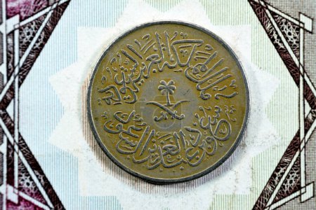 Photo for Crossed swords and palm tree at center of obverse side of old Saudi Arabia One piaster 5 five halalah coin 1378 AH, Translation of Arabic (King Saud Bin AbdulAziz Al Saud), vintage retro old coin - Royalty Free Image