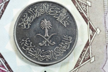 Photo for Crossed swords and palm tree at center of obverse side of old Saudi Arabia fifty Halalah 50 halalas Half Saudi Riyal coin 1400 AH, Translation of Arabic (King Khalid Bin AbdulAziz Al Saud) - Royalty Free Image
