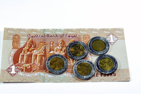 Photo for Egyptian 1 LE EGP One Egyptian pound coins on Egyptian banknote, Translation of Arabic (Police day 70 69 years) in the memorial of Egypt police day with a flying falcon, selective focus, isolated - Royalty Free Image