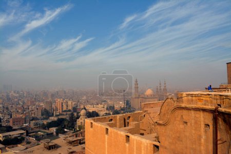 Téléchargez les photos : Cairo, Egypt, January 7 2023: Aerial view of old Cairo city from Salah El Din's citadel or the mountain castle showing multiple buildings in a cloudy and foggy weather, selective focus - en image libre de droit
