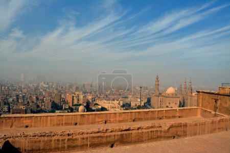 Photo for Cairo, Egypt, January 7 2023: Aerial view of old Cairo city from Salah El Din's citadel or the mountain castle showing multiple buildings in a cloudy and foggy weather, selective focus - Royalty Free Image