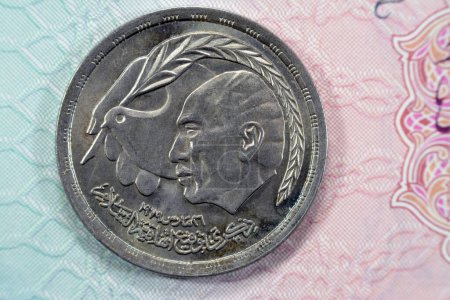 Photo for Commemorative 10 Ten Egyptian piasters of Egyptian-Israeli Peace Treaty features Anwar Sadat at right, dove of peace, hand with quill signing treaty on obverse side and date and value on reverse 1980 - Royalty Free Image