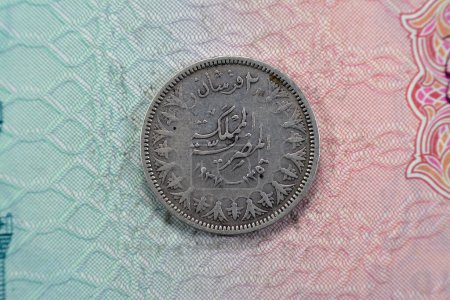 Photo for Ancient round old two 2 piasters coin at the era of king Farouk I features value and kingdom of Egypt on a side and a bust of King Farouk the 1st on the other side, vintage retro coin 1937 AD 1356 AH - Royalty Free Image