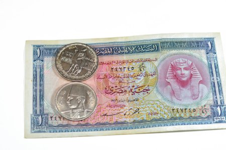Photo for Background of old Egyptian money banknotes and coins of One Egyptian pound 1 EGP LE banknote bill of king Tutankhamen and coin of Orabi Revolution and 10 ten Egyptian piasters of king Farouk I  First - Royalty Free Image