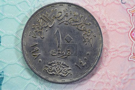 Photo for Ten Egyptian piasters 1980 AD 1400 AH commemorative of 18 March Day of the Egyptian Doctors, doctor's day Al Kasr Al Ainy with Seated healer with staff on obverse, date and value on reverse - Royalty Free Image