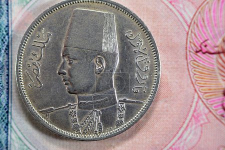 Photo for Ancient old ten 10 Egyptian piasters coin at the era of king Farouk I features value and kingdom of Egypt on a side and a bust of King Farouk the 1st on the other side, vintage retro coin 1939 AD - Royalty Free Image