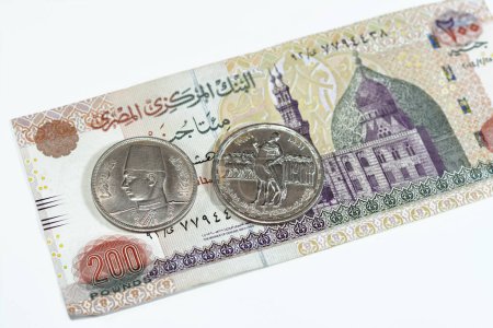 Photo for Background of old Egyptian money banknotes and coins of two hundred pounds 200 EGP LE banknote bill of Qani Bay mosque and coin of Orabi Revolution and 10 ten Egyptian piasters of king Farouk I first - Royalty Free Image
